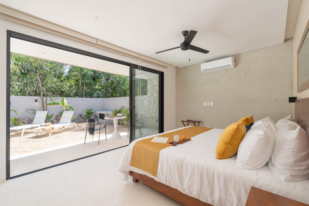 King sized bed and view of garden and plunge pool