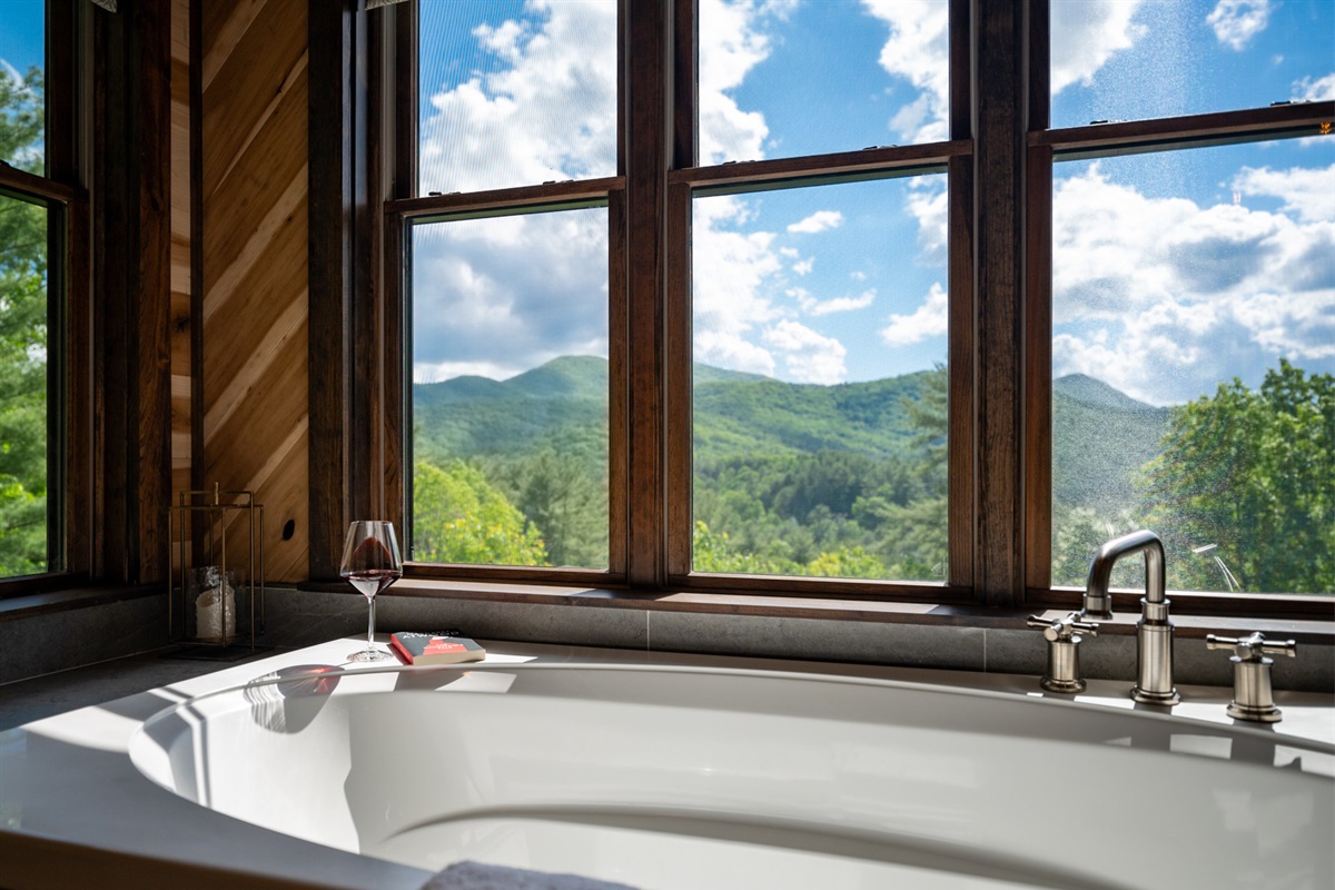 Soak your worries away in this tub with expansive views of the lush green mountains.