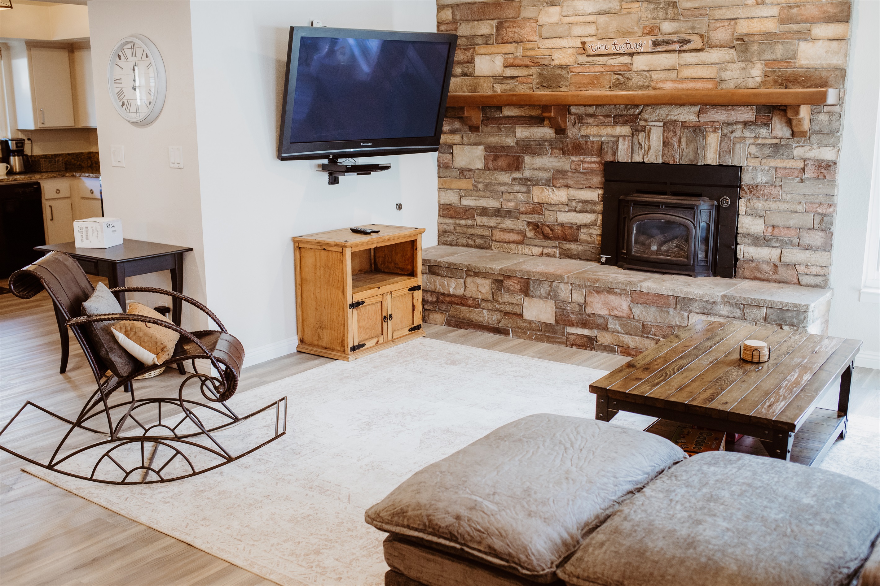 A cozy living space anchored by a stone fireplace.