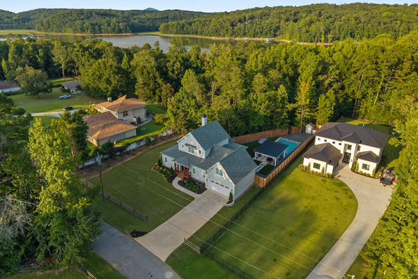 A peaceful Lake Lanier escape: Pool Villa Lanier sits in a quiet neighborhood surrounded by mature trees, with beautiful lake views just beyond the property. Guests can take the golf cart along a short wooded trail to access the lake.