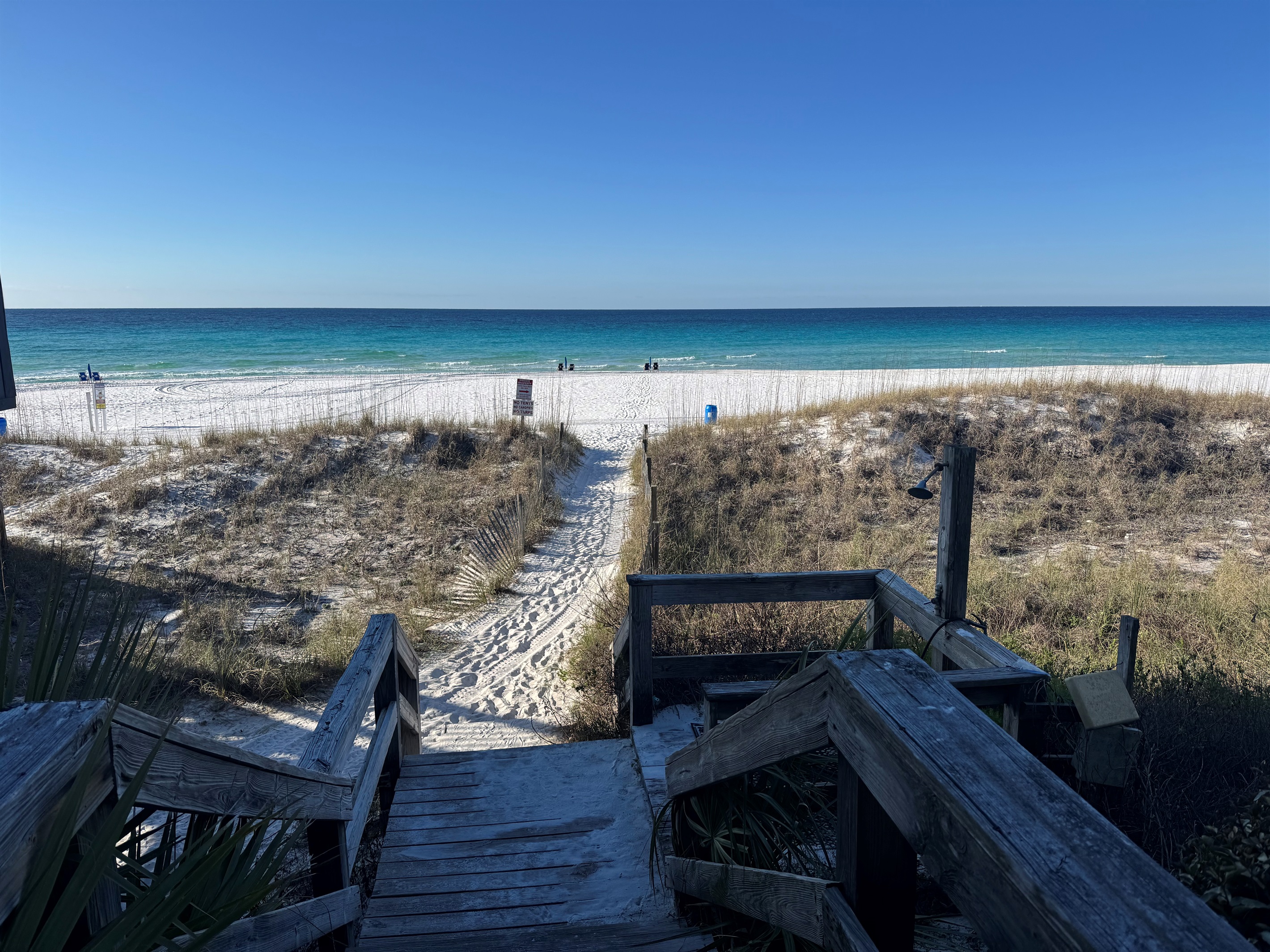 Path to the beach, with a shower to wash off when you are done! 

The beachfront across all of Destin was renourished so as long as you stay within 30 feet from water you can enjoy. No tents or canopies are allowed!