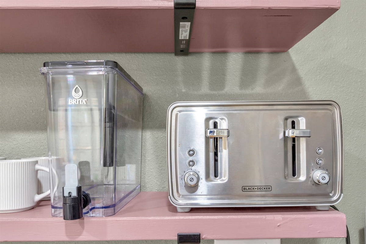 Thoughtful touches like a Brita pitcher, double toaster, and coffee mugs make this kitchen perfect for relaxed, extended Dallas stays.