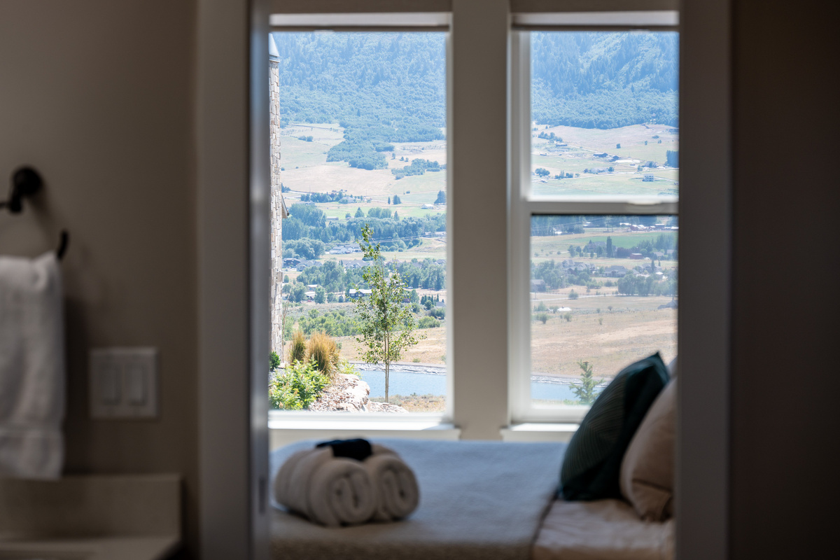 Even the ensuite bathroom offers breathtaking views of the surrounding mountains.