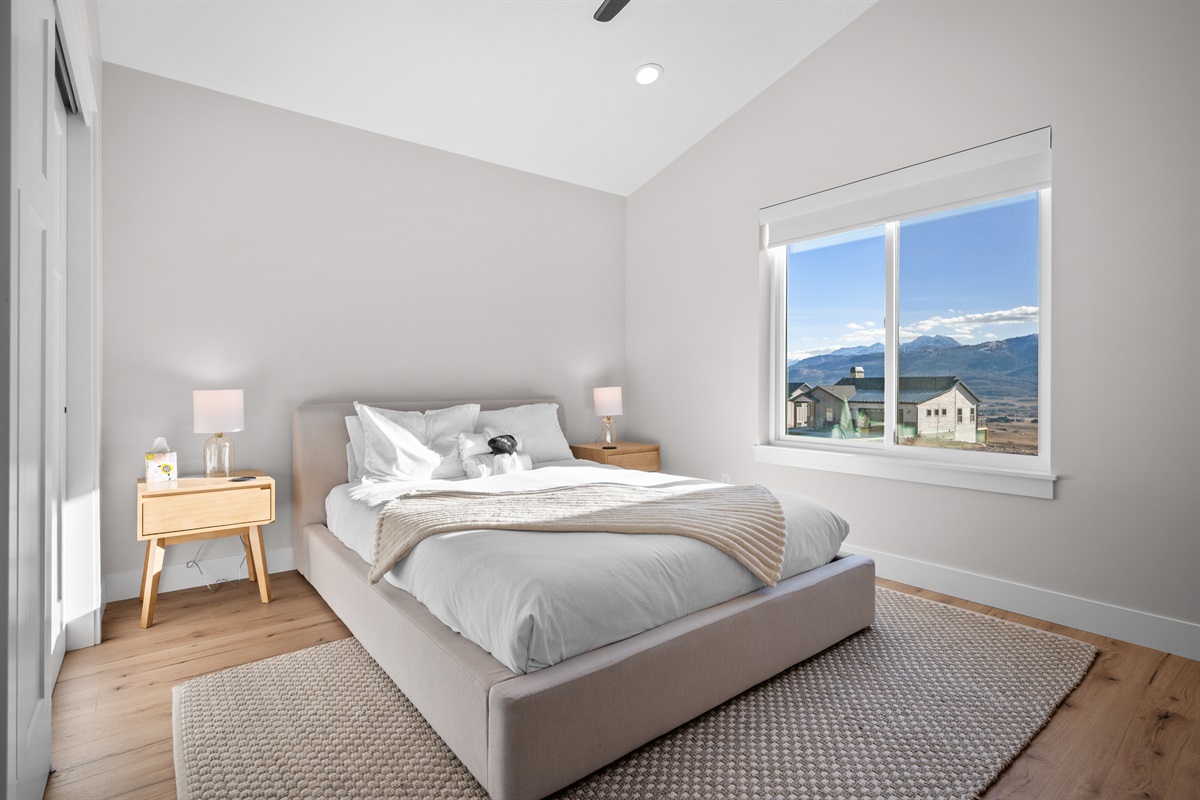 Main-Level Queen Bedroom with beautiful mountain views and calming, neutral design.