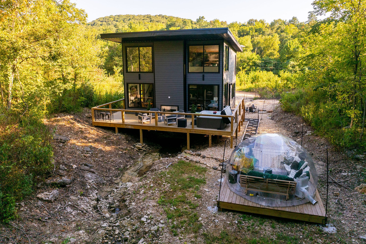 Modern glass architecture tucked into the Ozark woods near Table Rock Lake.