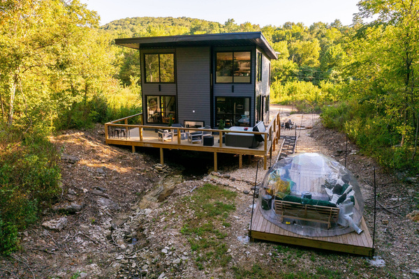 Modern glass architecture tucked into the Ozark woods near Table Rock Lake.