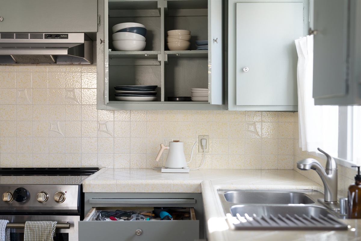 Plenty of tableware and cooking utensils.