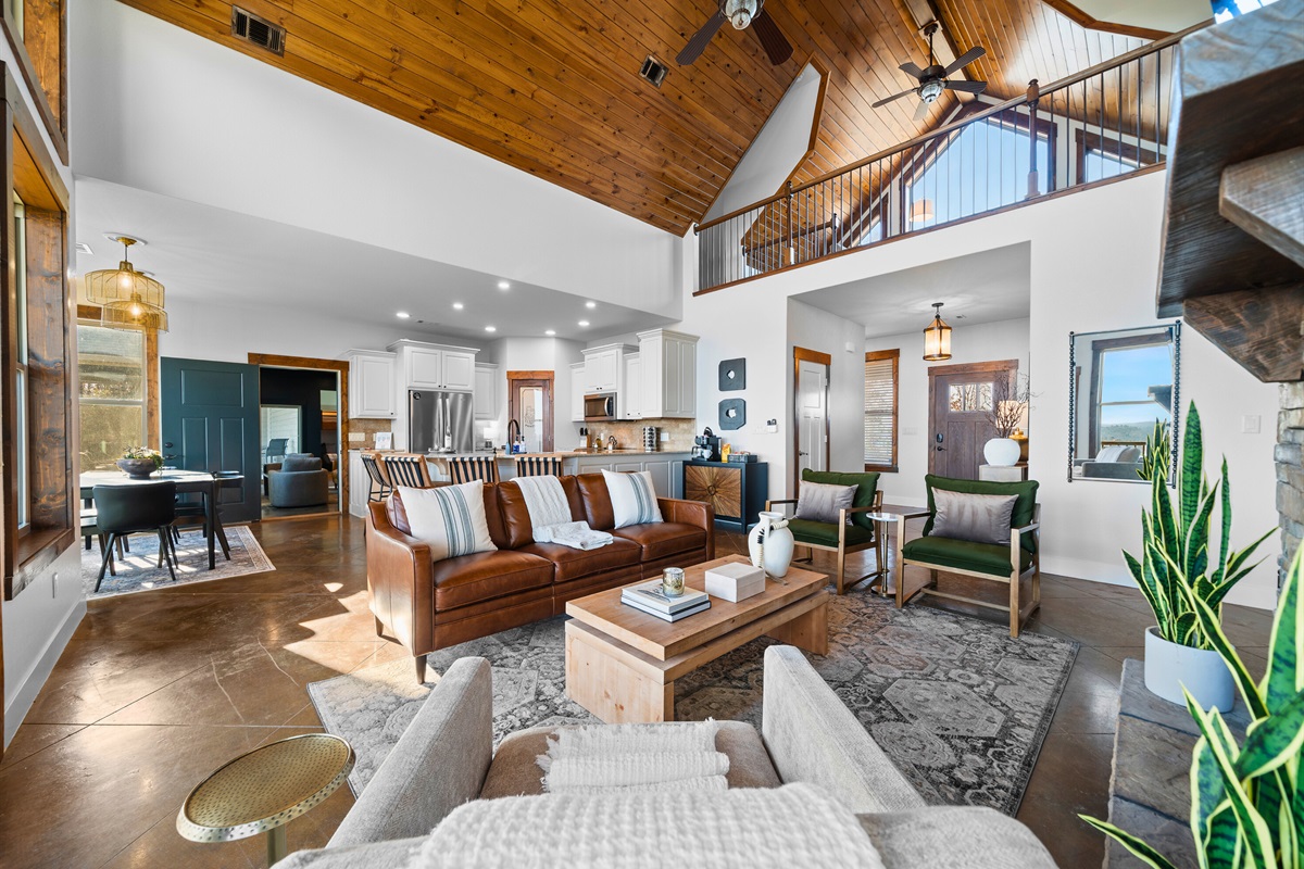 From the lofted ceilings to the seamless flow into the kitchen and dining areas, the main living space feels spacious, airy, and perfect for entertaining.