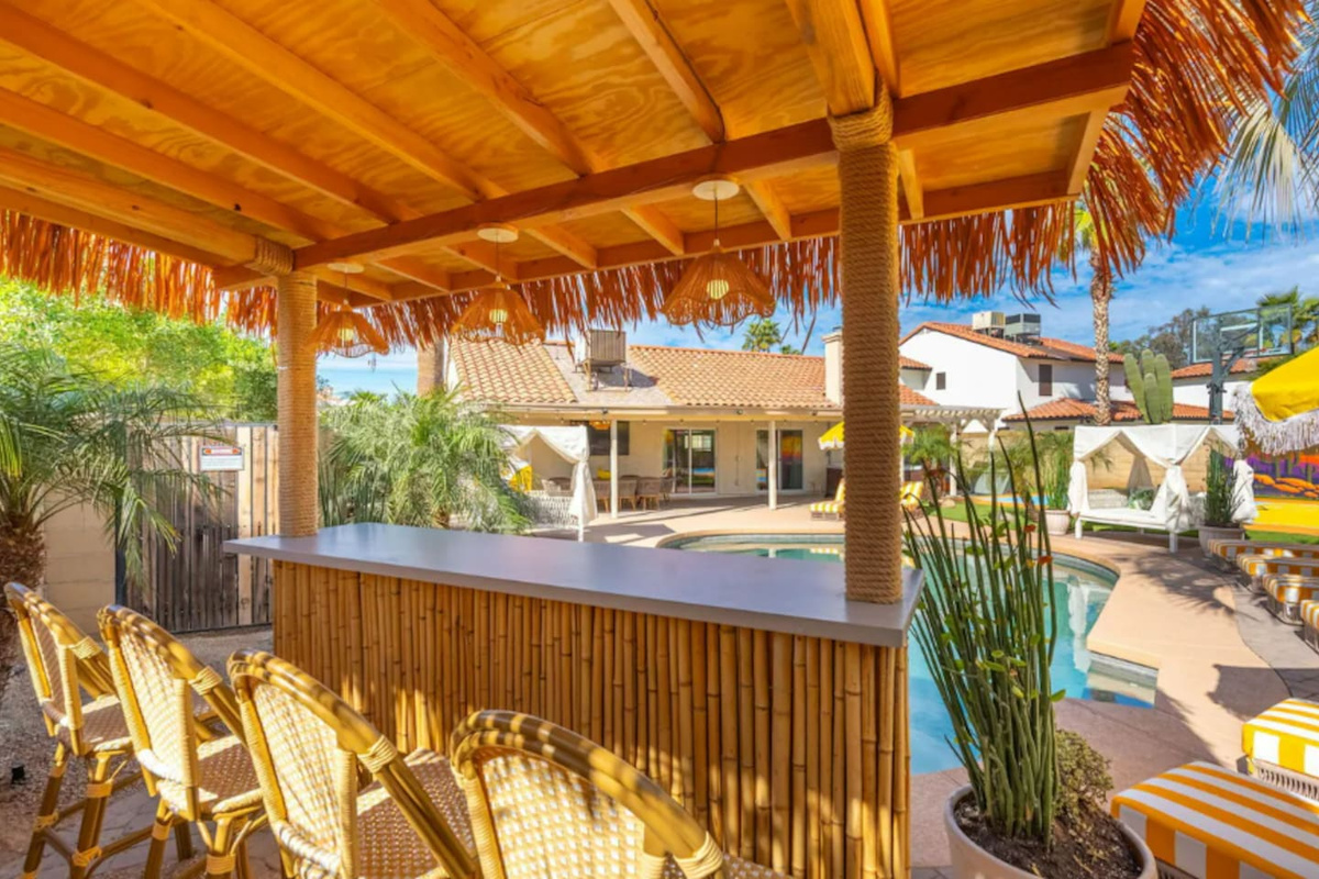 Tiki-style outdoor bar with lounge seating and pool views—your private resort oasis for sunset drinks and good company.