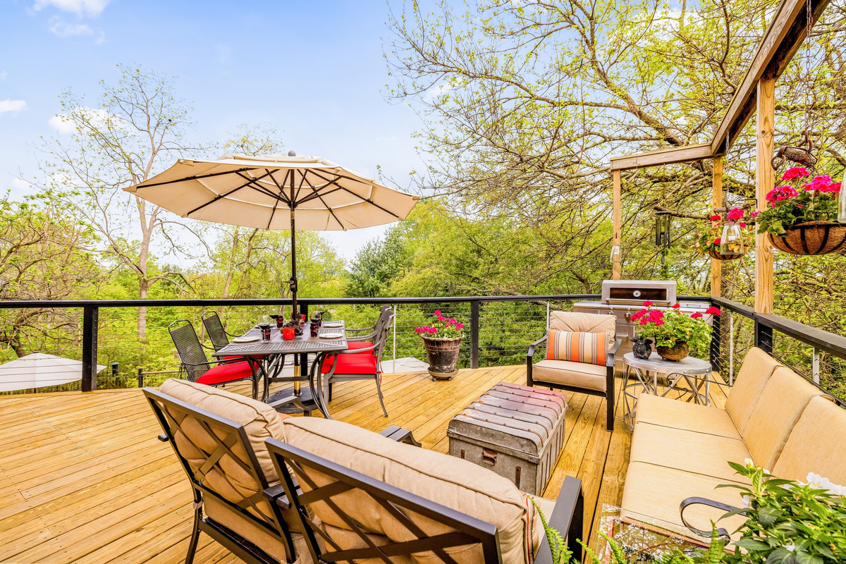 The main floor deck's territorial view, multiple lounge seats, and dining table are the perfect gathering place for friends and family to gather. With two spacious stories inside and out, Hilltop's retreat feel provides space to be close  or spread out.
