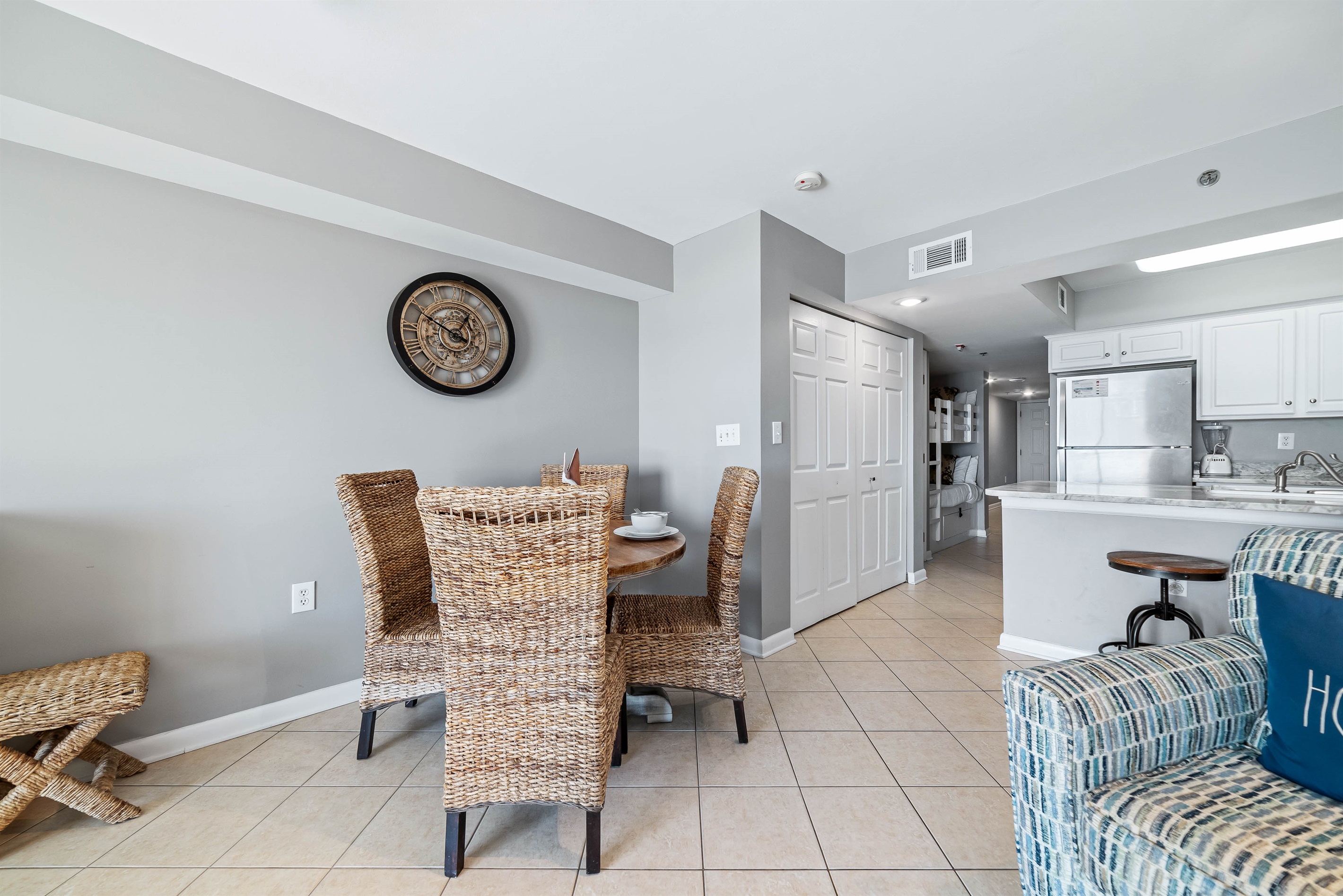 Dine in style with ample space for everyone. This inviting dining area features a charming table for family meals, complemented by additional seating at the convenient breakfast bar.
