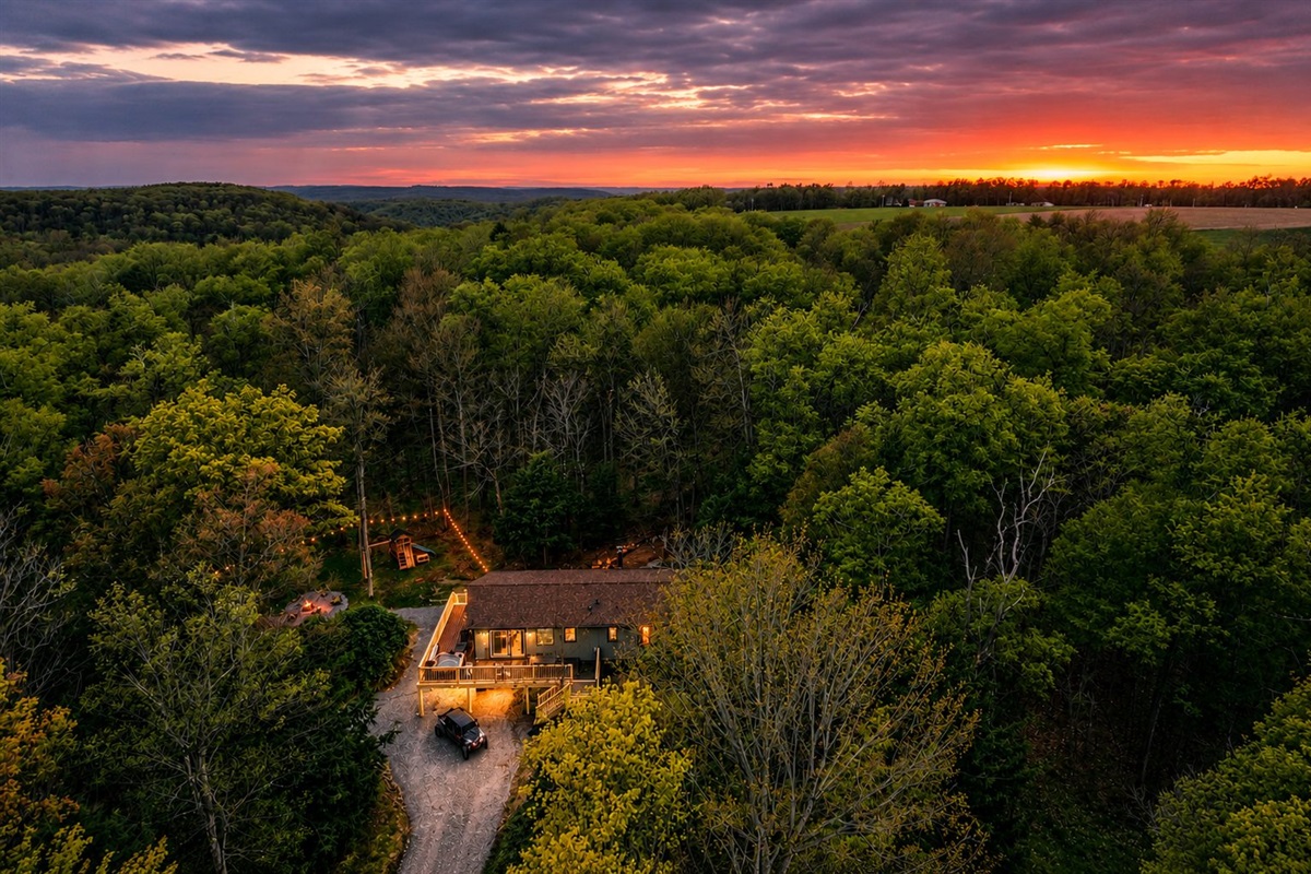 🏡 The cabin aglow beneath a fiery sky.