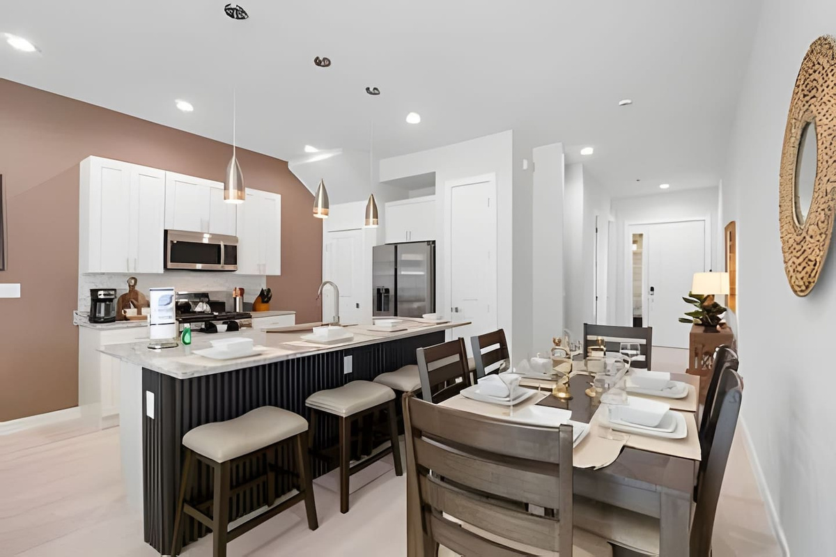 Spacious kitchen and dining setup, perfect for meal prep, casual dining, or gathering with friends.
