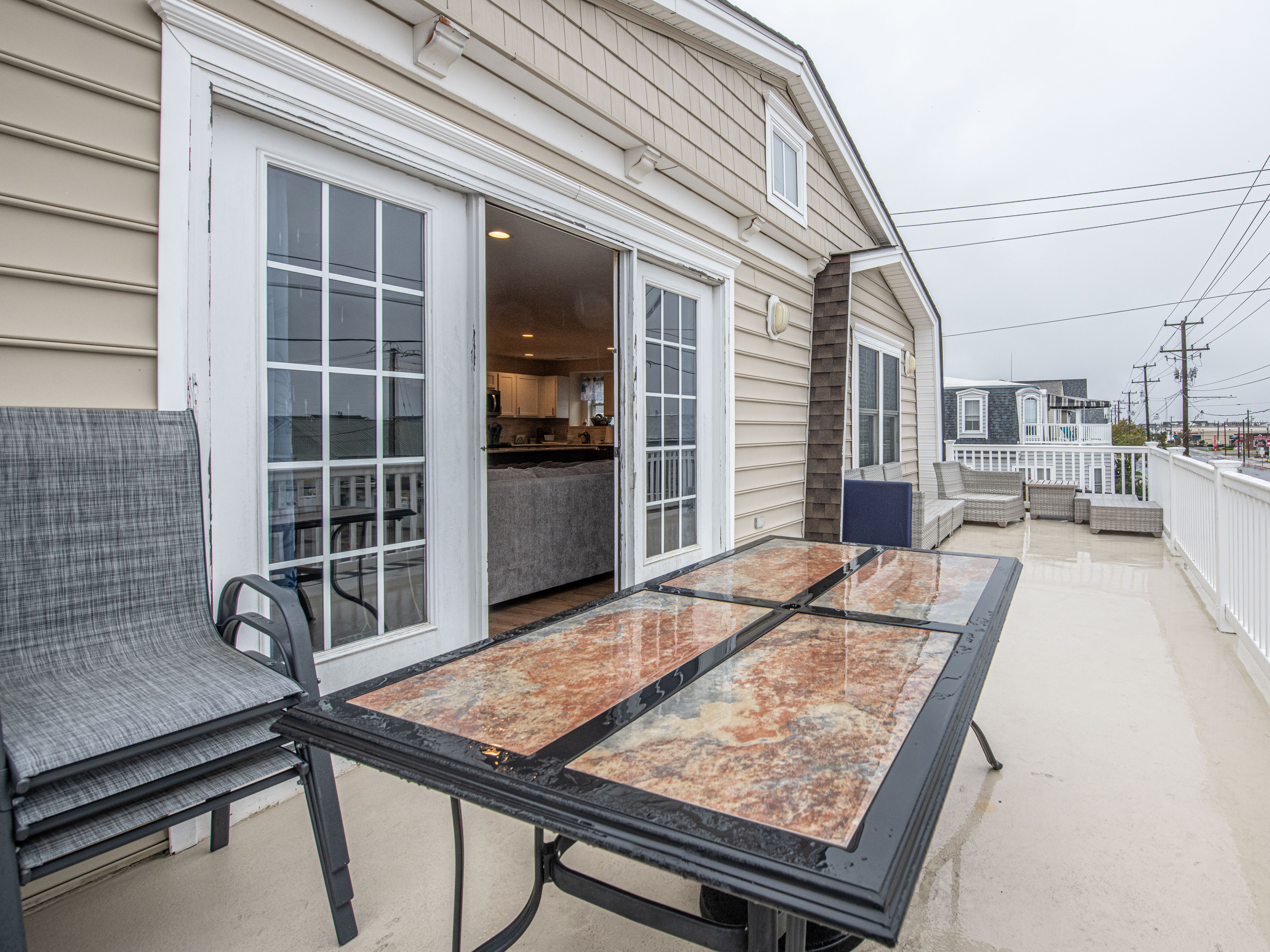 Outdoor Deck with Glass-Top Dining Table and Patio Seating