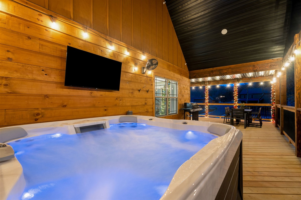 Private hot tub under the covered deck, ready to enjoy.