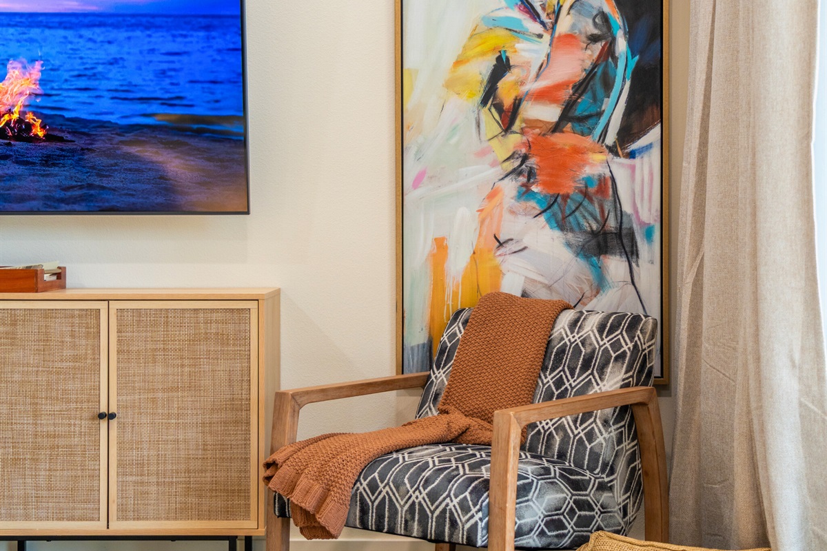 Bright reading nook with colorful artwork and warm lighting.