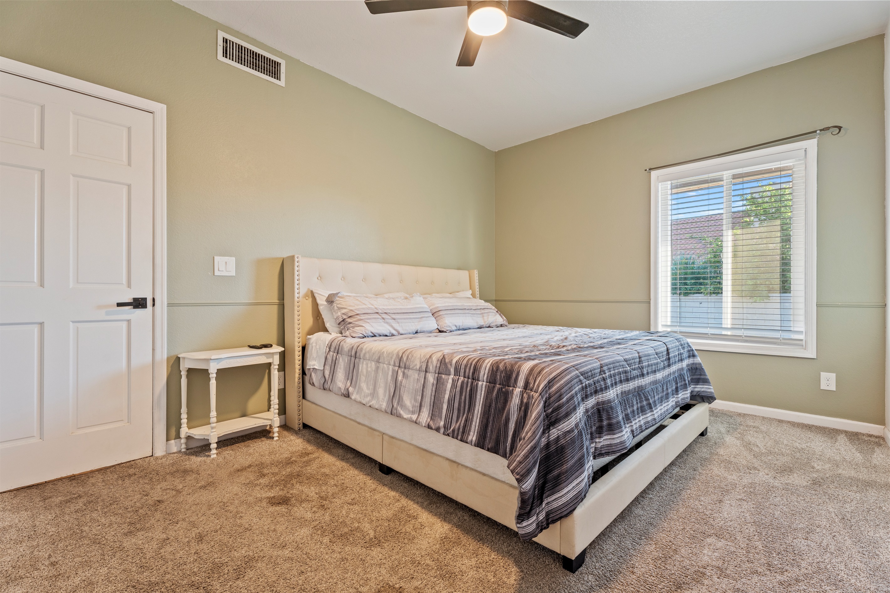Peaceful and earthy, this relaxing bedroom features a queen bed, soft tones, and a calming corner to truly unwind.