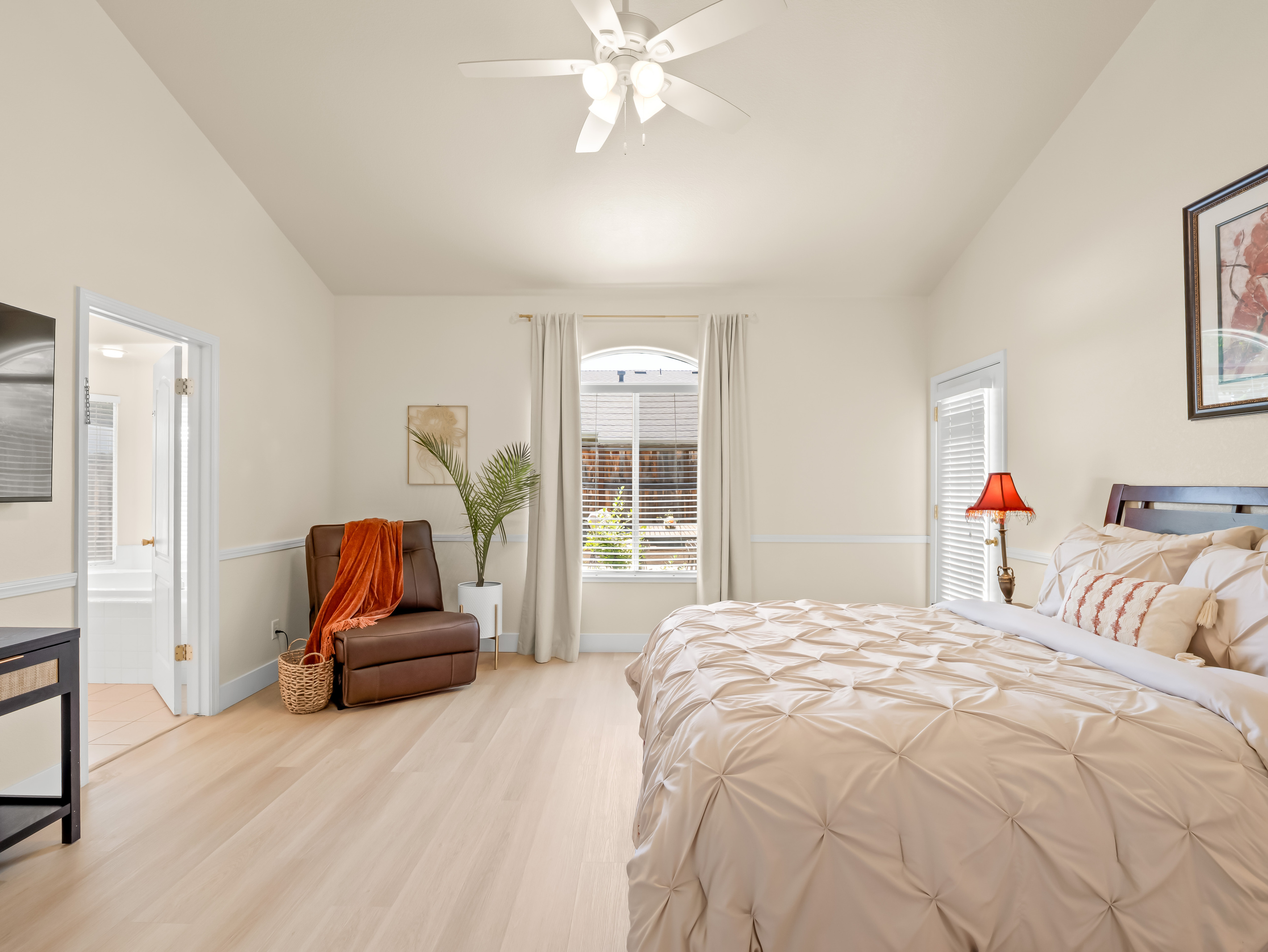 Enjoy restful nights and peaceful mornings in this bright and airy bedroom. The comfortable bed, cozy recliner, and calming décor create a welcoming space you'll love coming back to each day.