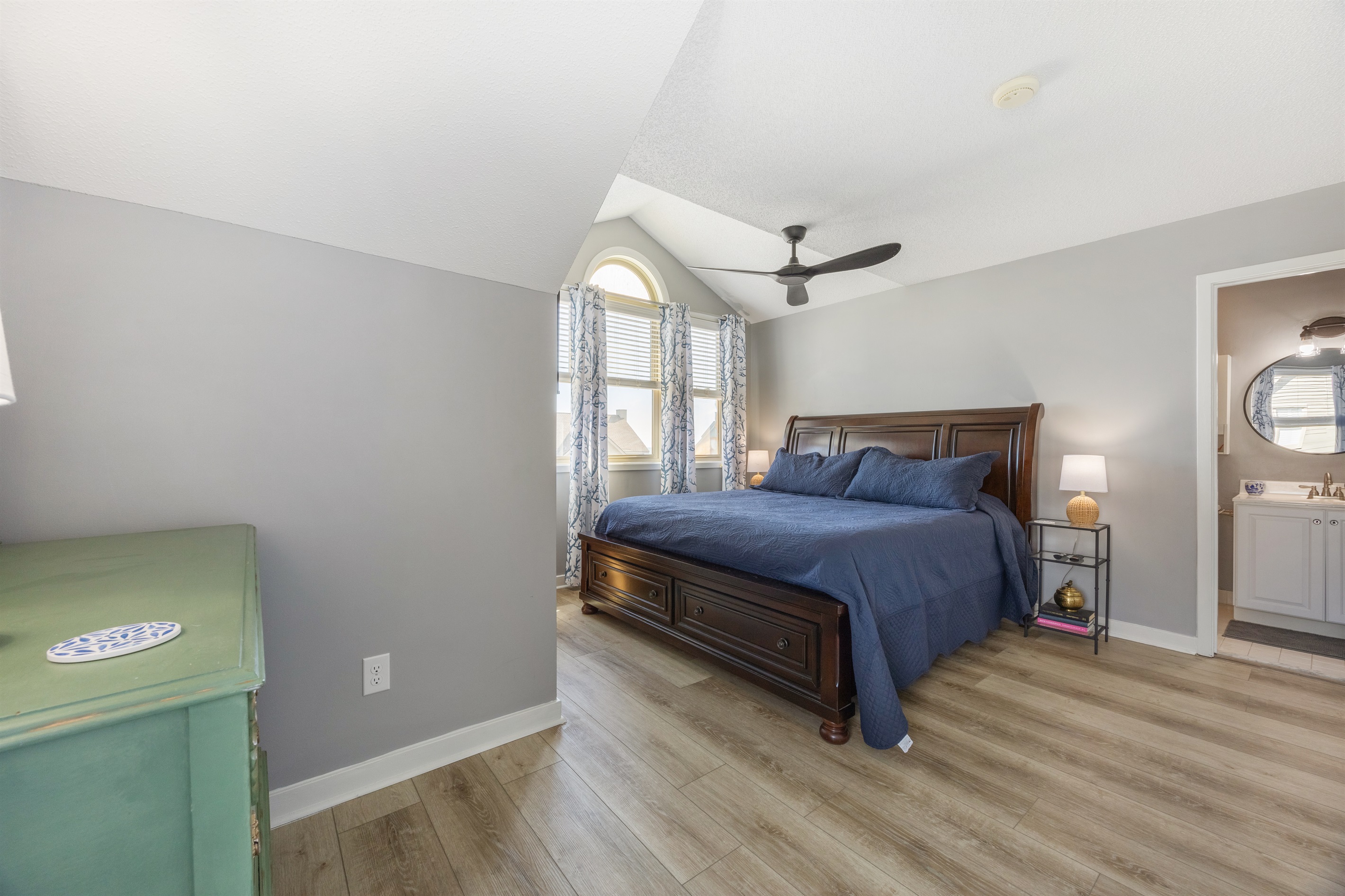 King bedroom with ensuite bath and TV—your private Topsail Beach retreat.