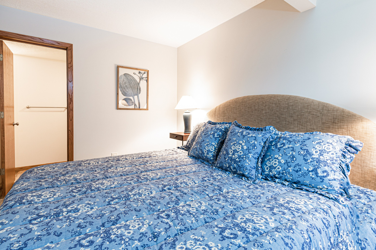 Main level bedroom features a king bed and an ensuite bathroom