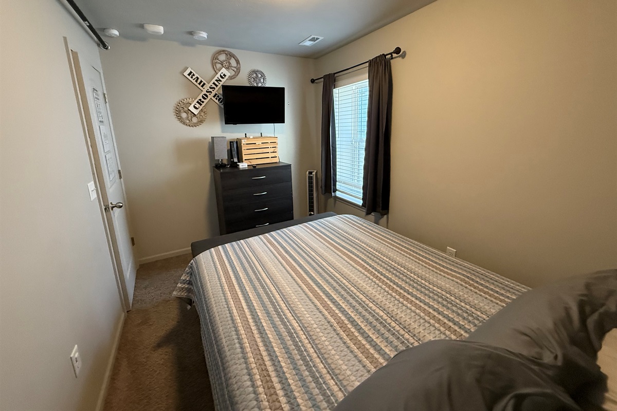 queen bed with 32" streaming tv for relaxing after a busy day