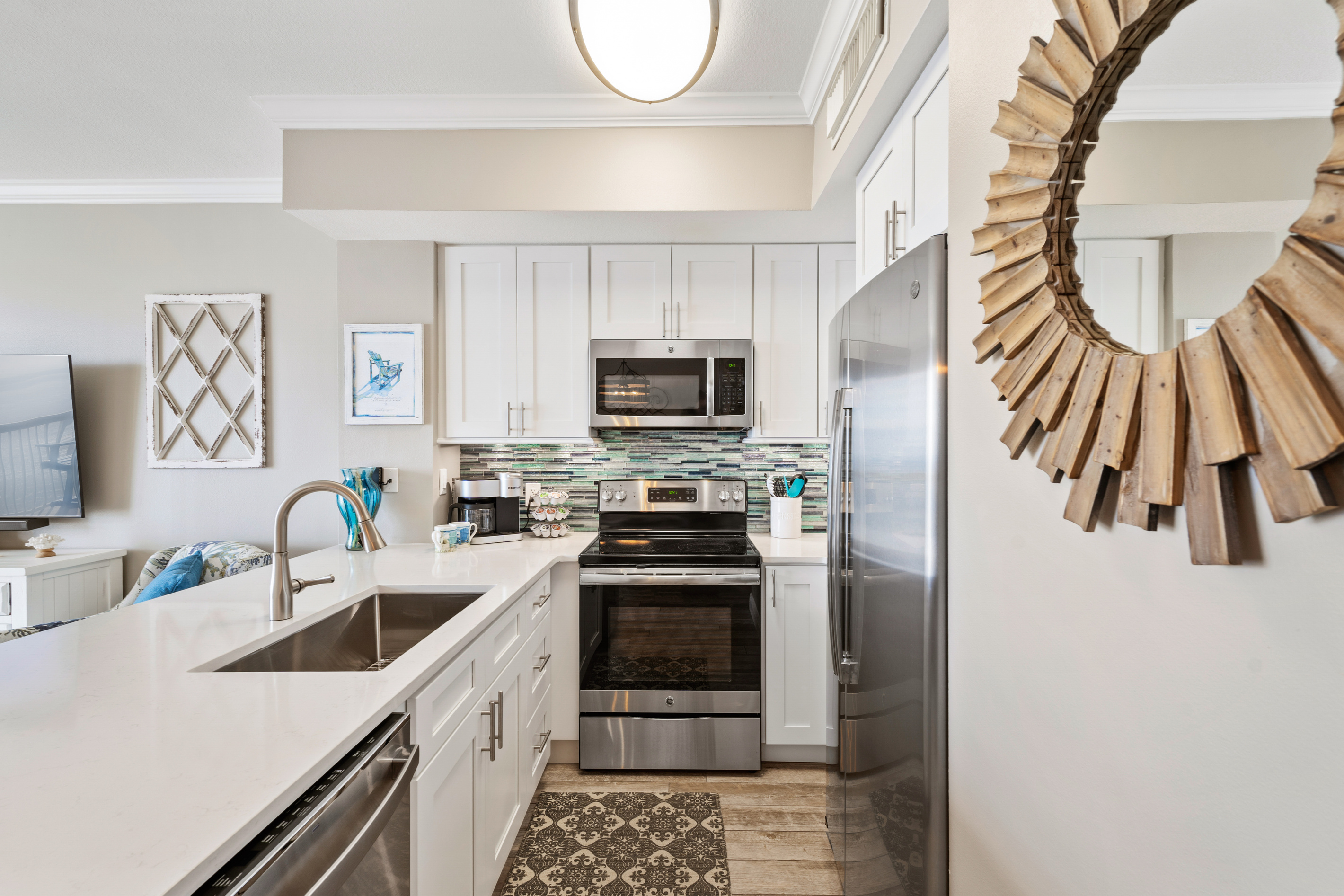 Quartz countertops, glass tile backsplash and LED undermount lighting