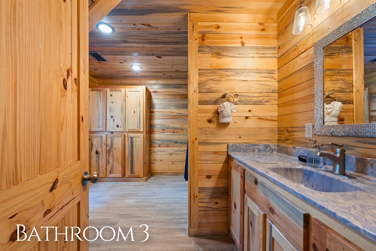 Finished with rustic cabin details, this bathroom provides a functional and comfortable space that fits naturally with the rest of the home.