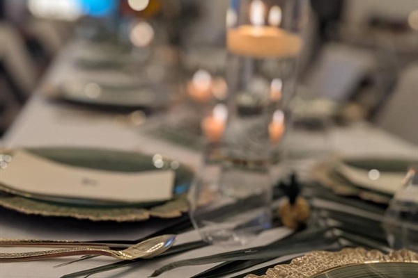 Tables, chairs, multiple pieces of place setting provided