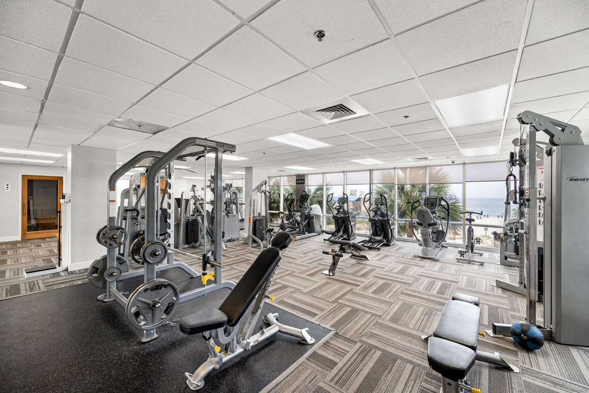 Fitness room with cardio and strength equipment overlooking the Gulf.