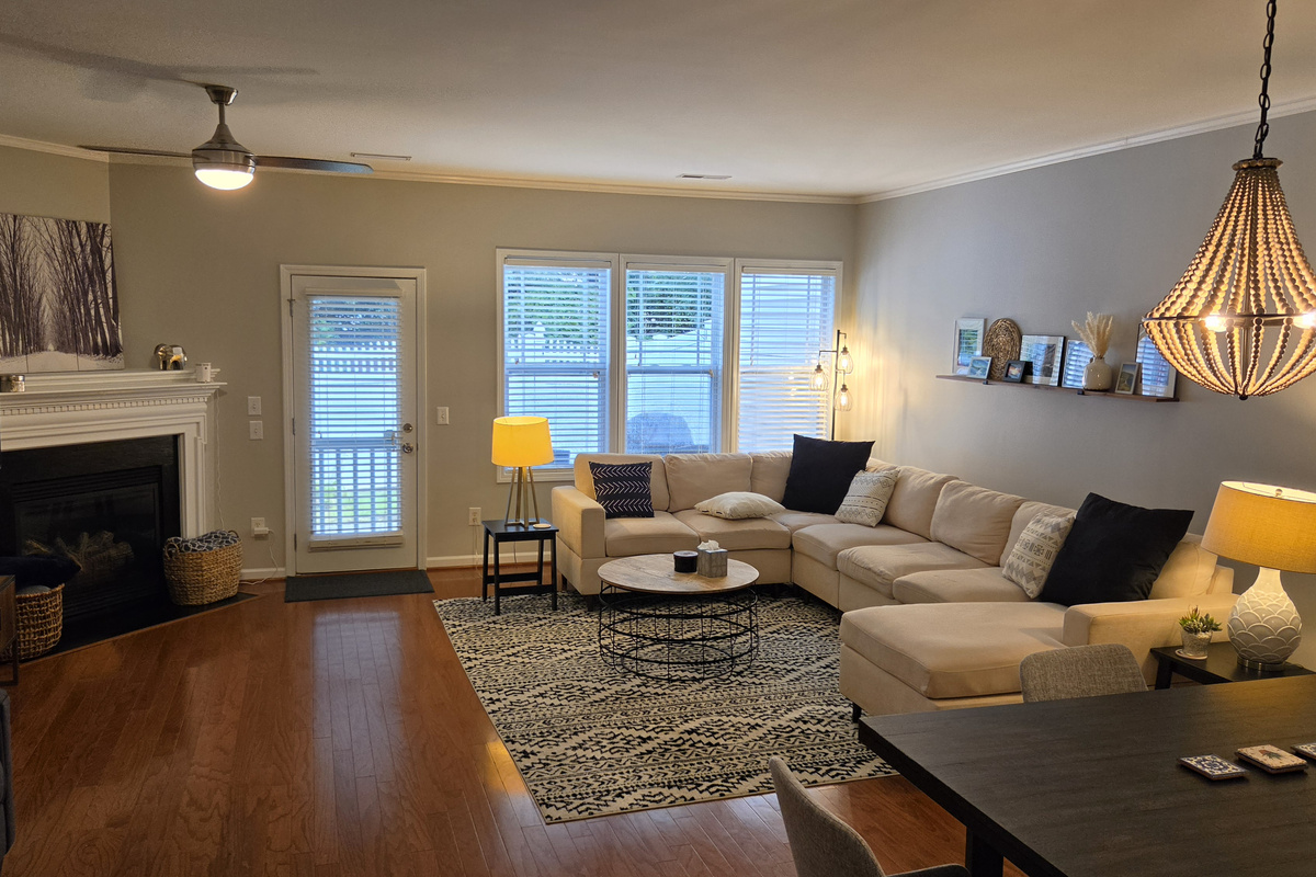 Living room with fireplace, backyard access, dining area