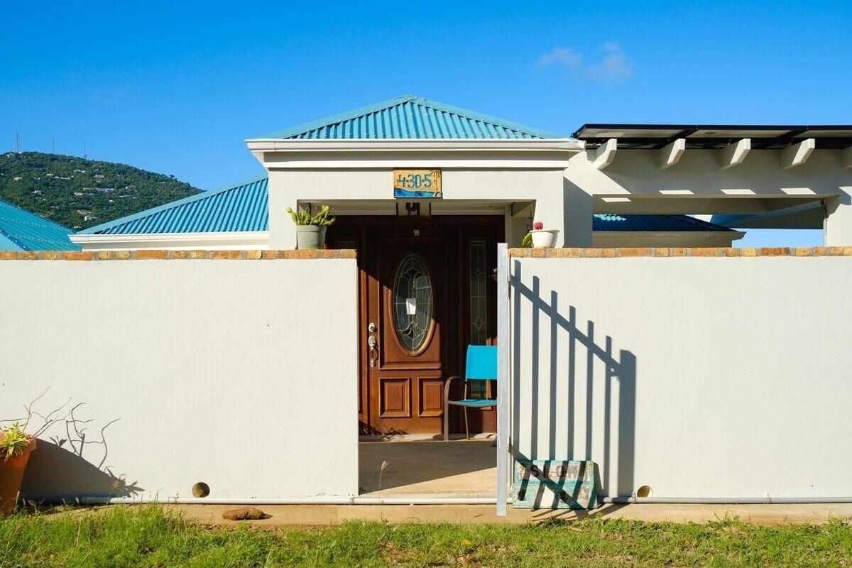 A secure concrete wall surrounds the home.