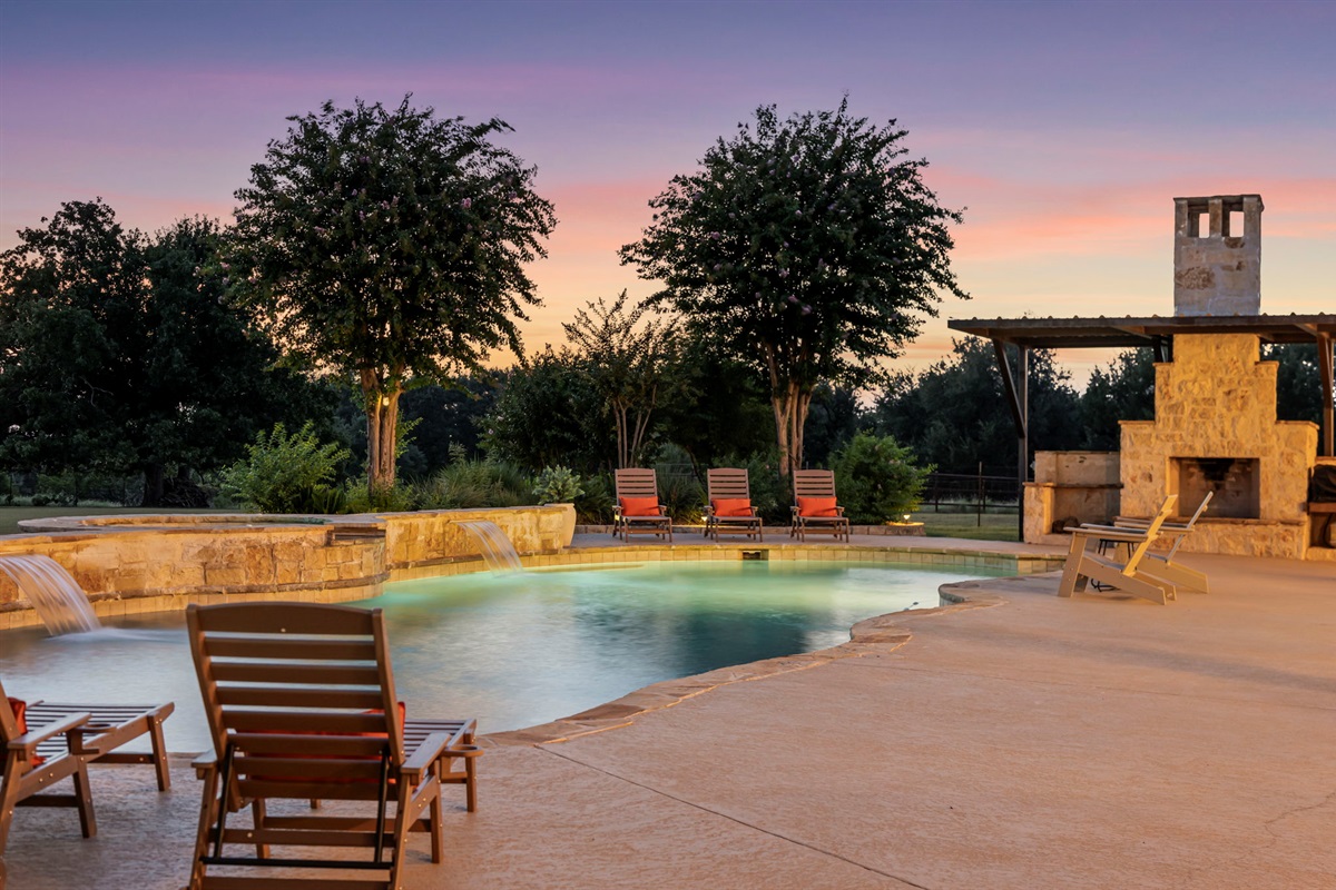 Evening tranquility by the poolside fireplace.