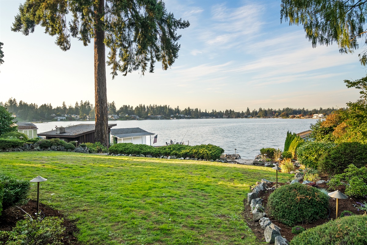 Scenic and expansive backyard leading down to the waterfront.
