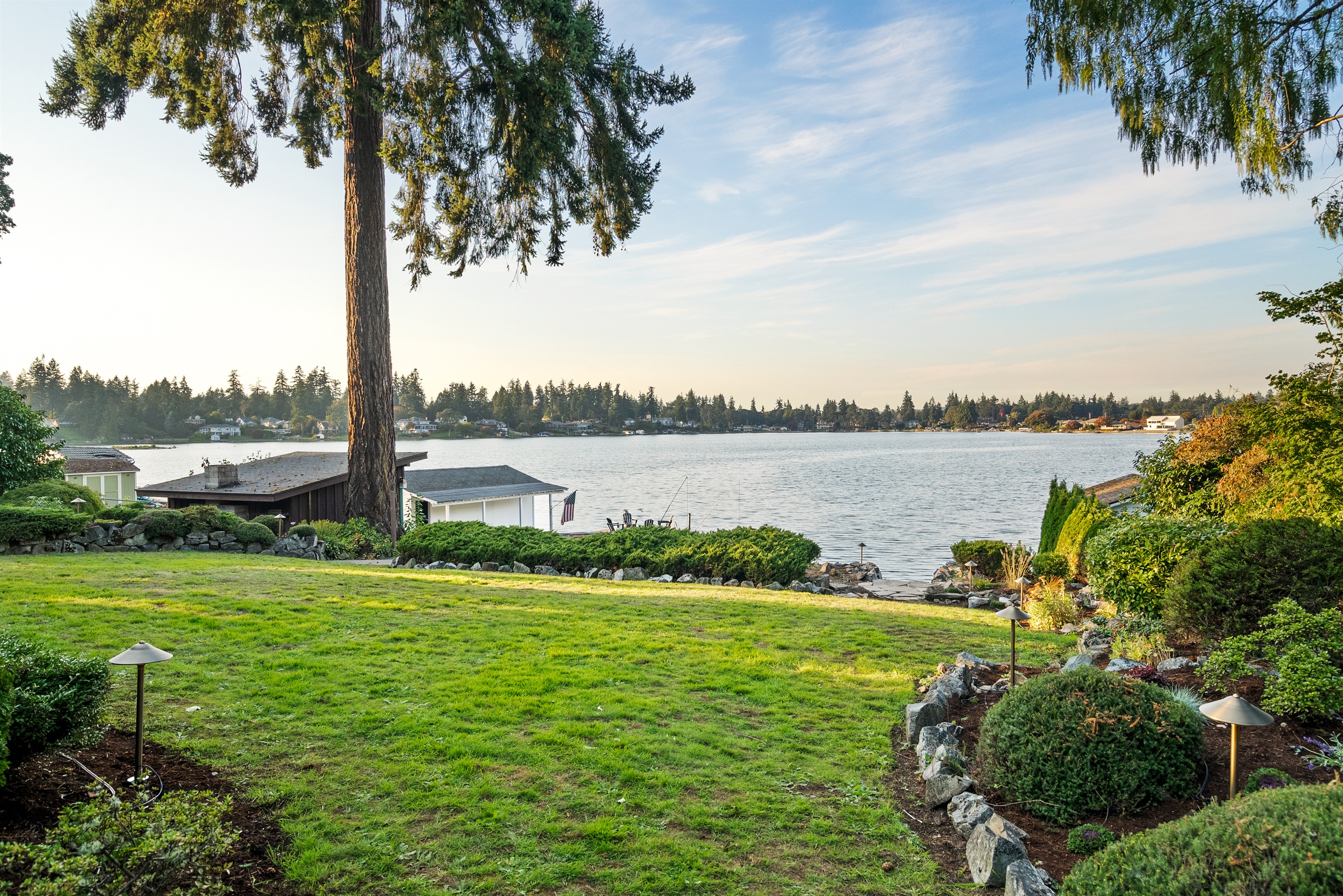 Scenic and expansive backyard leading down to the waterfront.