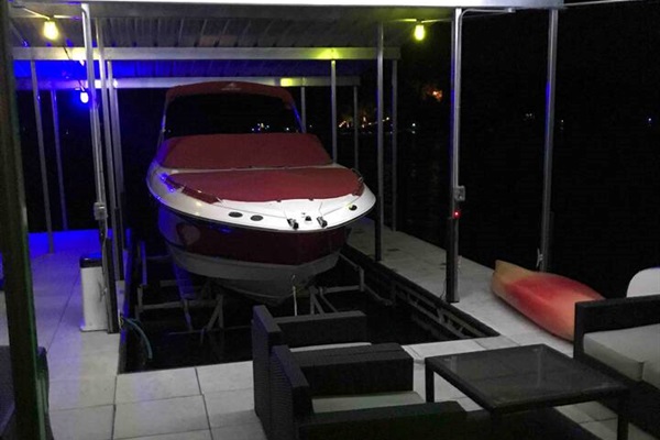 Lights on the dock at night for fishing and lounging. Owner's boat/lift (not part of rental).