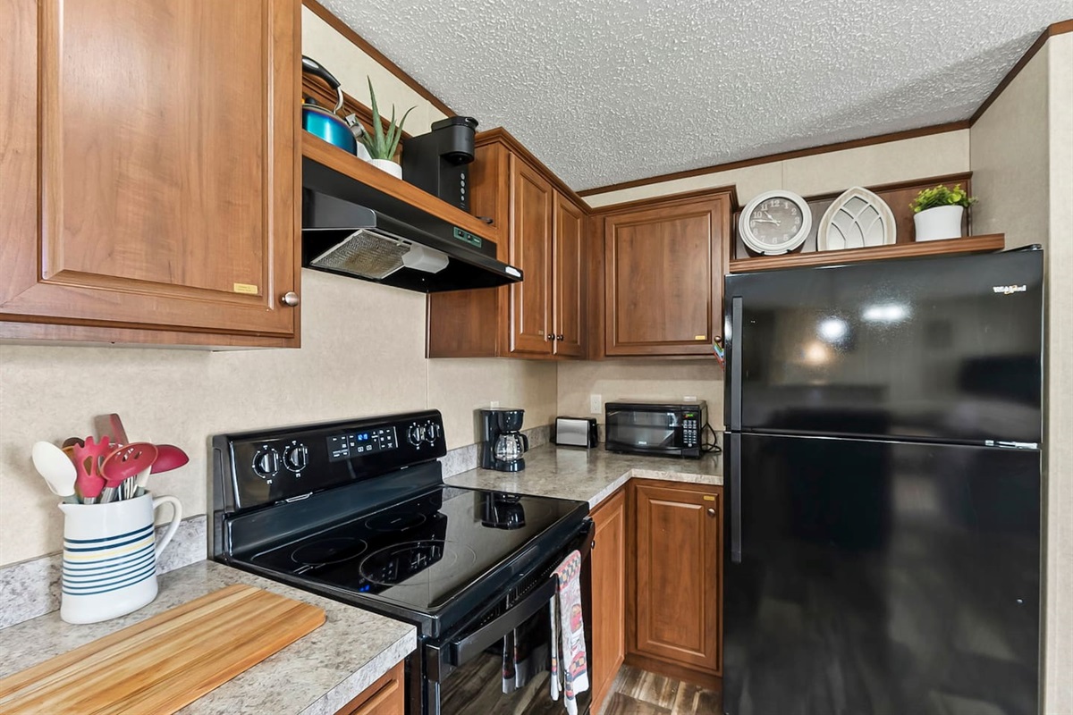 Well-stocked kitchen with coffee maker, microwave, and essentials—perfect for quick breakfasts or relaxed dinners.