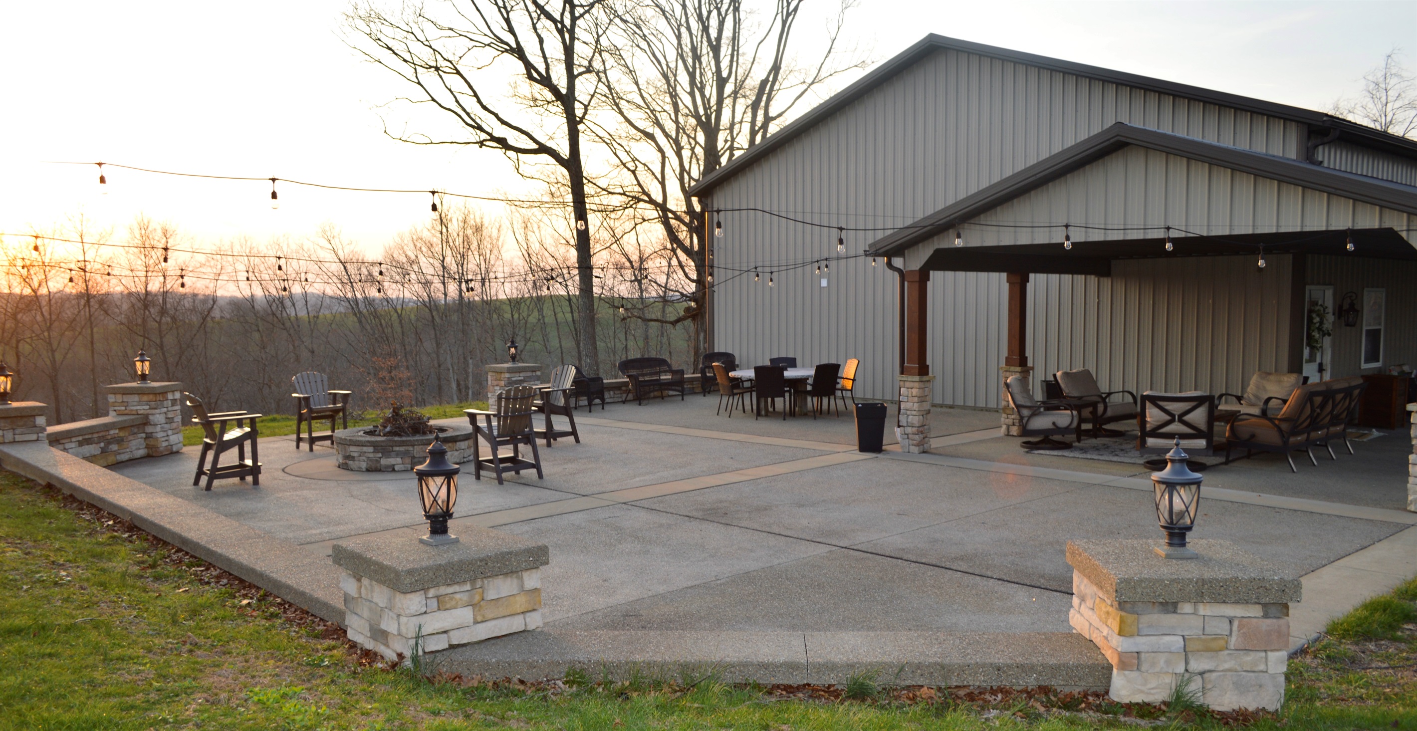Spacious outdoor patio with fire pit, dining area, and covered seating