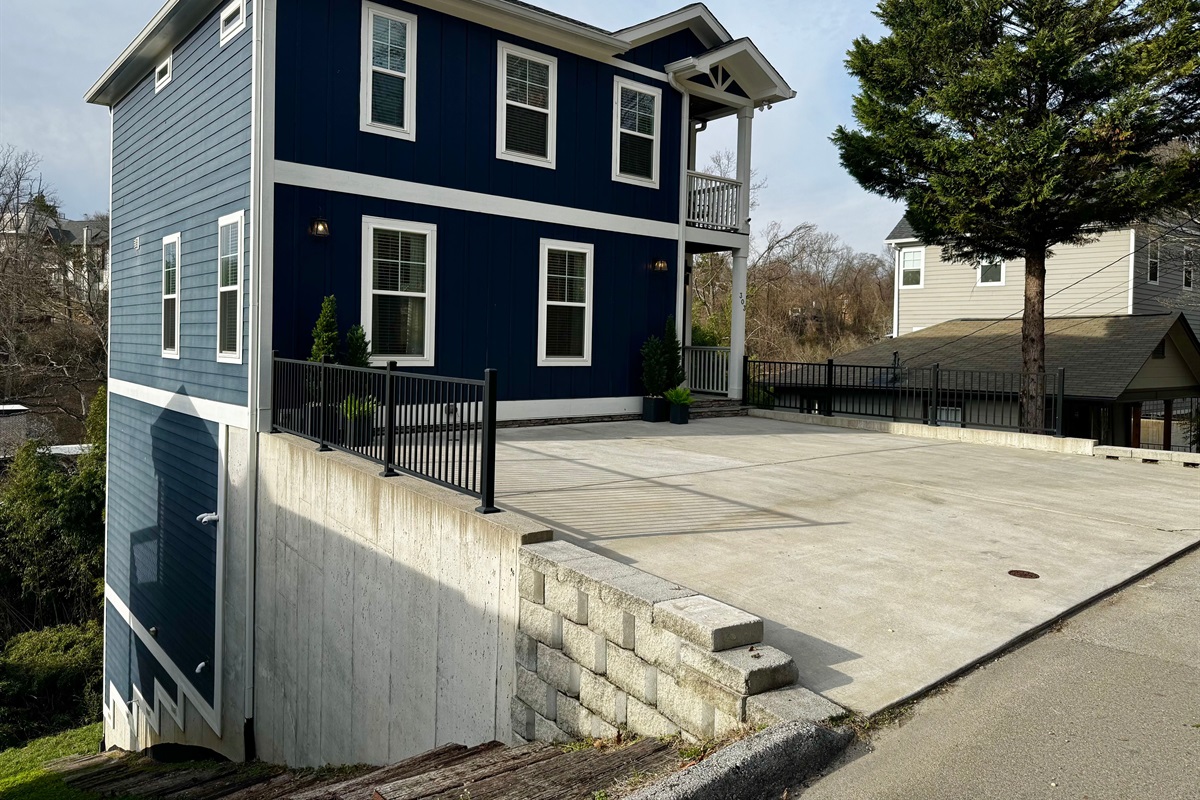 Stairs along the left side of the house provide access to the lower back deck and small back yard with a bamboo forest.