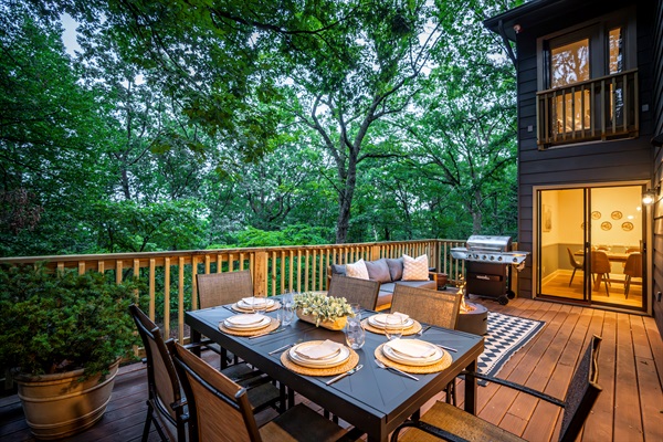 Main level deck directly off kitchen / dining / living area - with extendable 8 person table, sofa, gas firepit, and gas grill. 