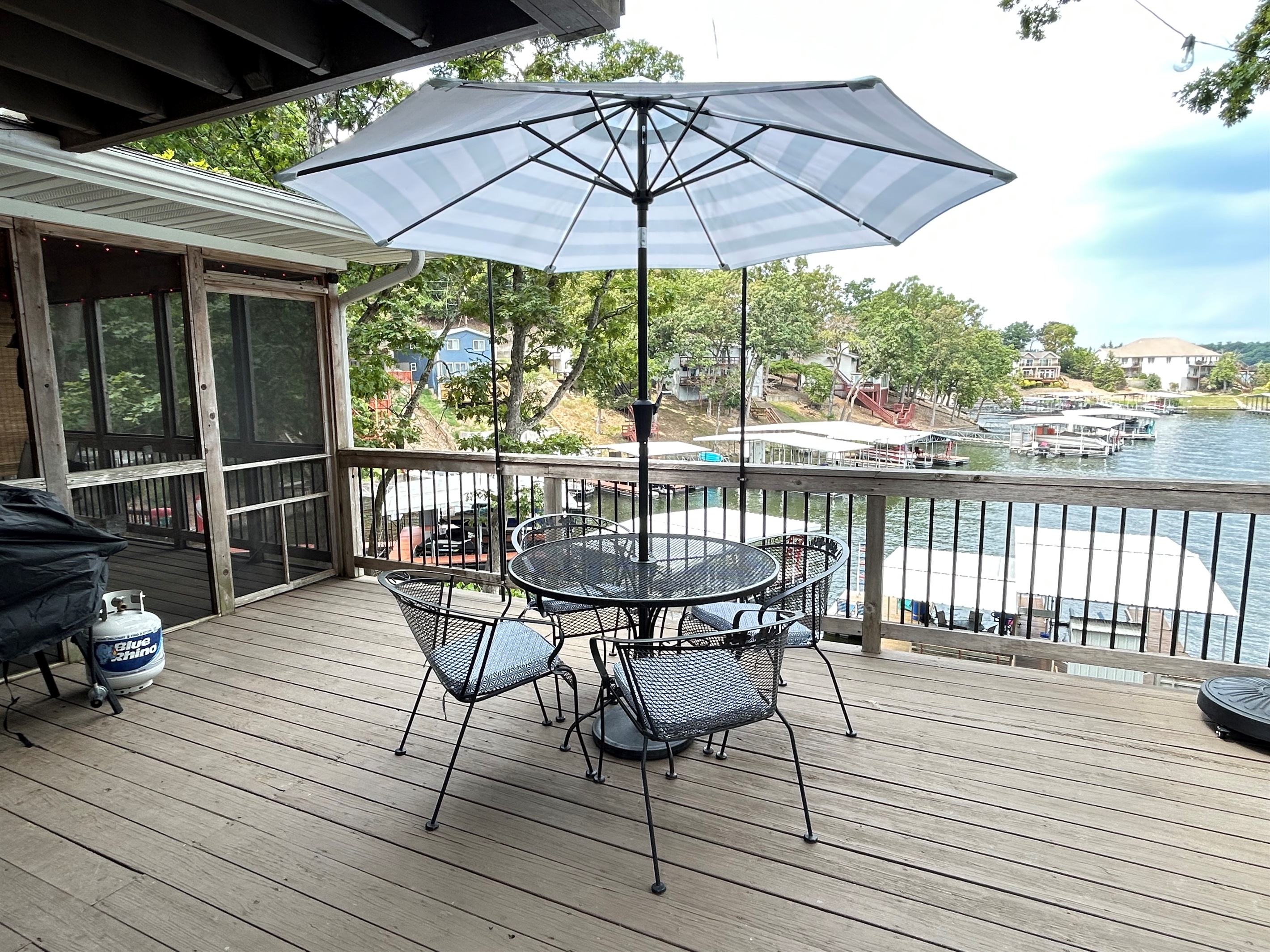Open deck with additional dining, Blackstone grill, gas grill, and charcoal grill