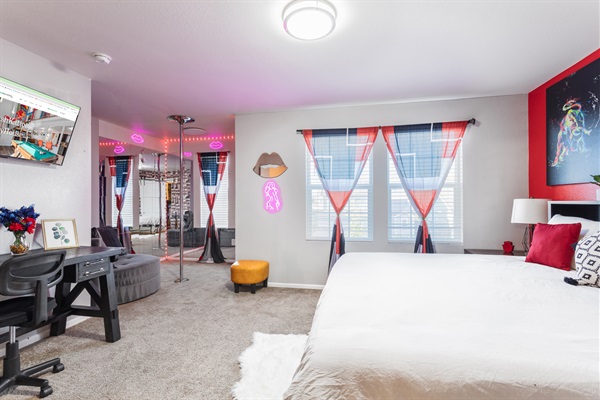 Master Bedroom: A serene retreat of comfort and style, featuring a luxurious king-sized bed, striking red accent walls, and captivating artwork that blends creativity with relaxation.