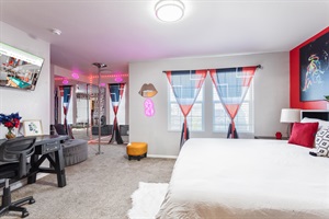 Master Bedroom: A serene retreat of comfort and style, featuring a luxurious king-sized bed, striking red accent walls, and captivating artwork that blends creativity with relaxation.