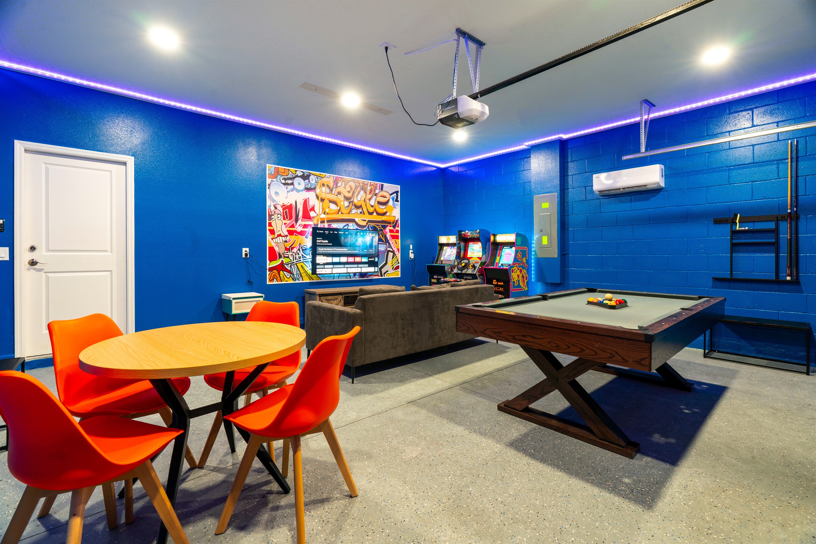 Game room features a classic pool table, smart TV, cozy couch, and board games—ideal for family fun and friendly competition.