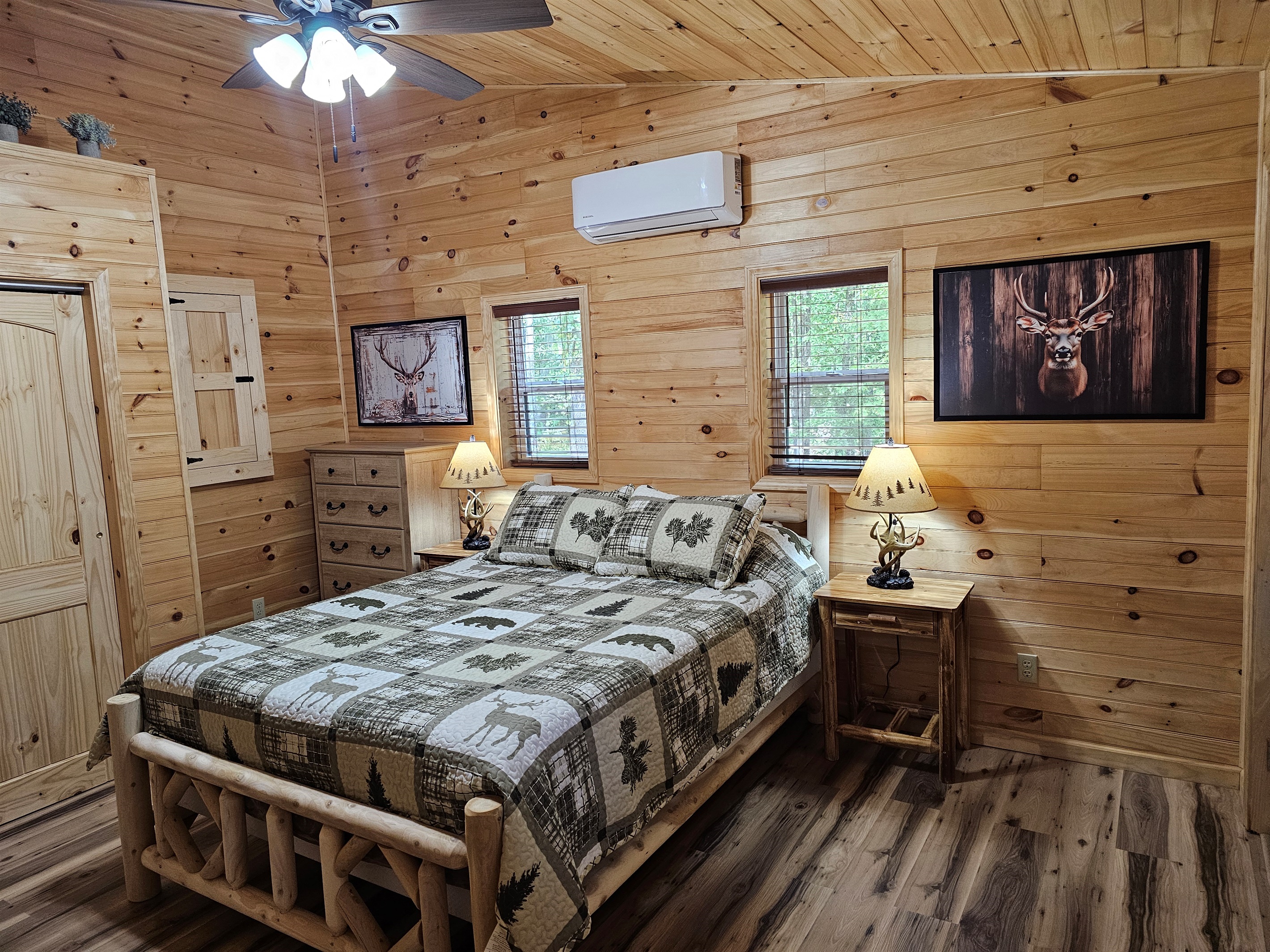 Drift off beneath cabin-style quilts and soft lamplight — a romantic retreat tucked in the trees.