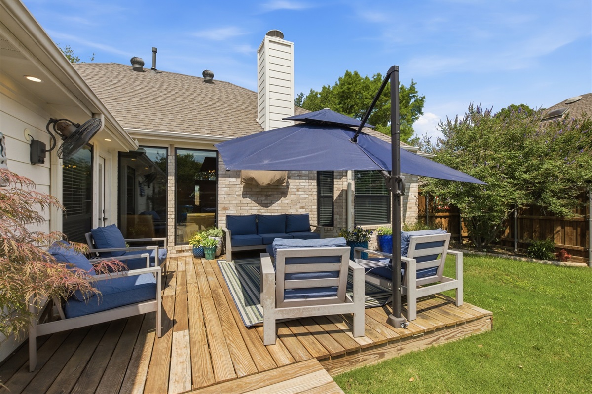 Spacious raised Patio with deep-cushioned Outdoor Furniture, shade umbrella, and direct lawn access. Perfect for morning coffee or after-dinner drinks under the Texas sky.
