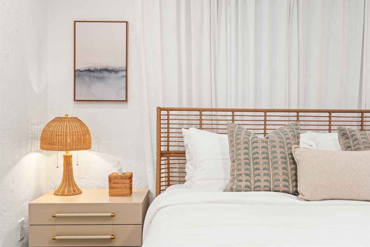 Layered pillows, warm lighting, and organic textures bring effortless coastal luxury.