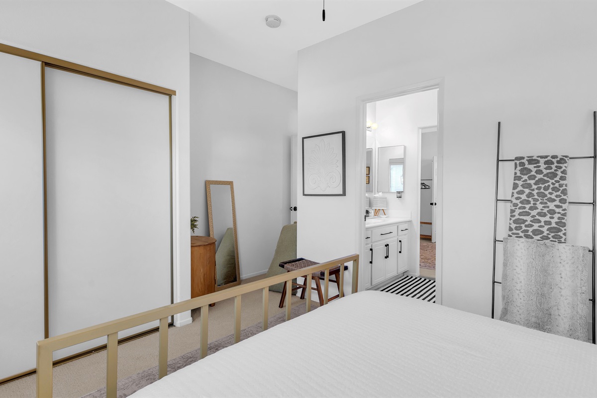 Spacious and thoughtfully designed guest room with mirrored closet doors and soft, neutral décor