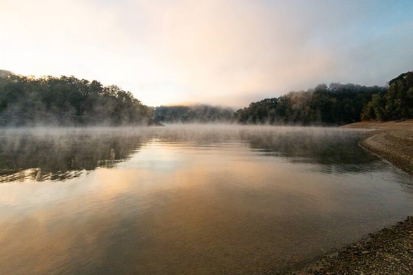 From the shoreline by the boat ramp, witness the lake come alive with morning fog and sunlight.