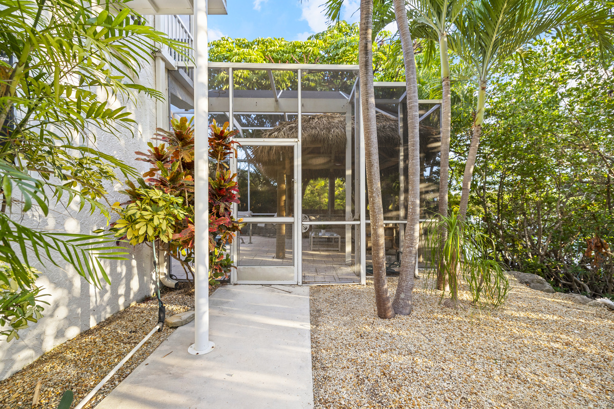 The entire pool area is enclosed with netting, keeping the "noseeums" away while you enjoy the tropical back yard.