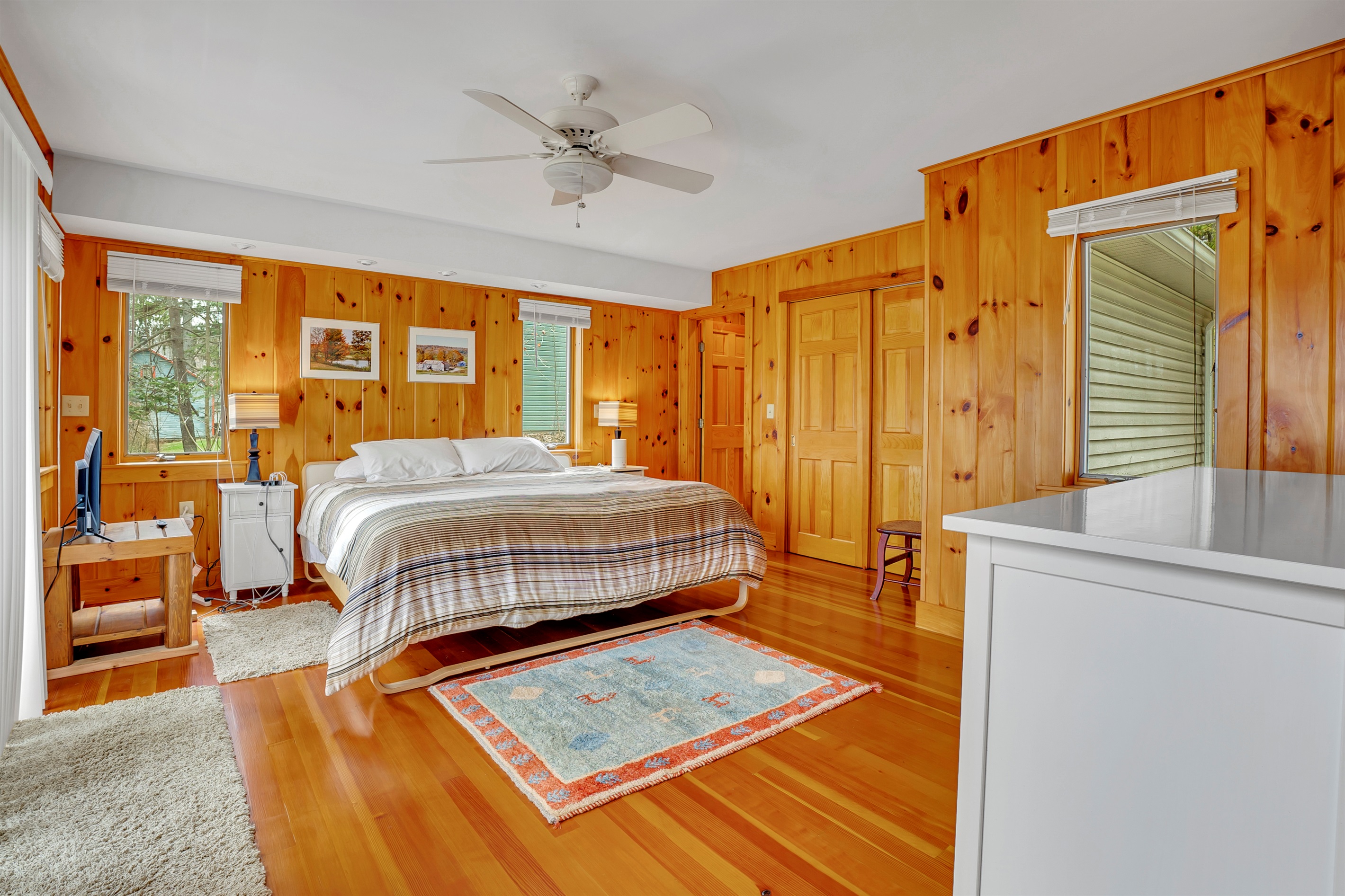 King primary bedroom with deck access and ensuite bath